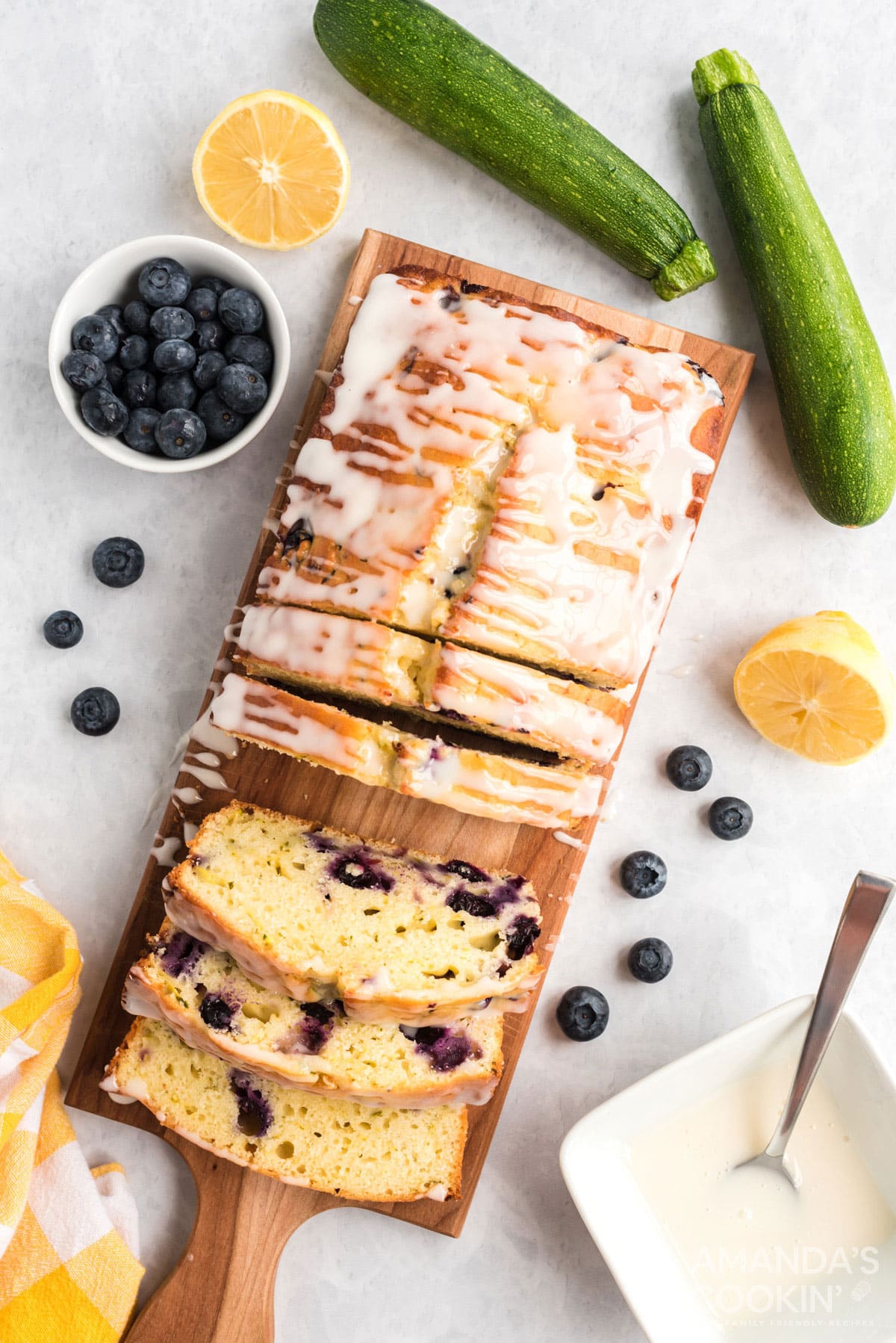 overhead photo of sliced lemon blueberry zucchini bread on a cutting board