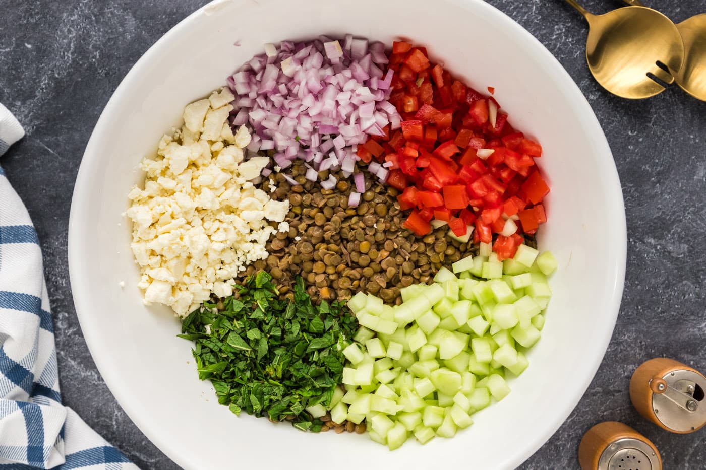 lentils, roma tomatoes, shallots, cucumber, feta, and fresh mint in a bowl