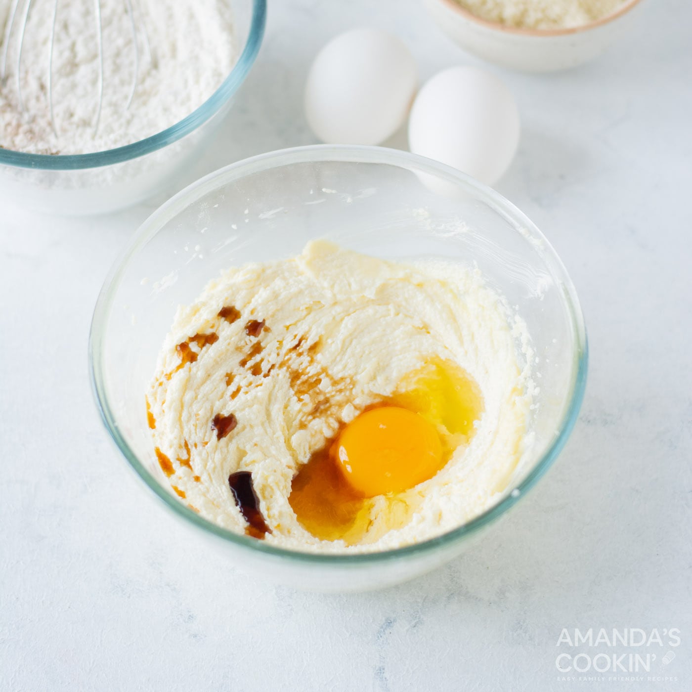 egg and vanilla in butter and sugar mixture