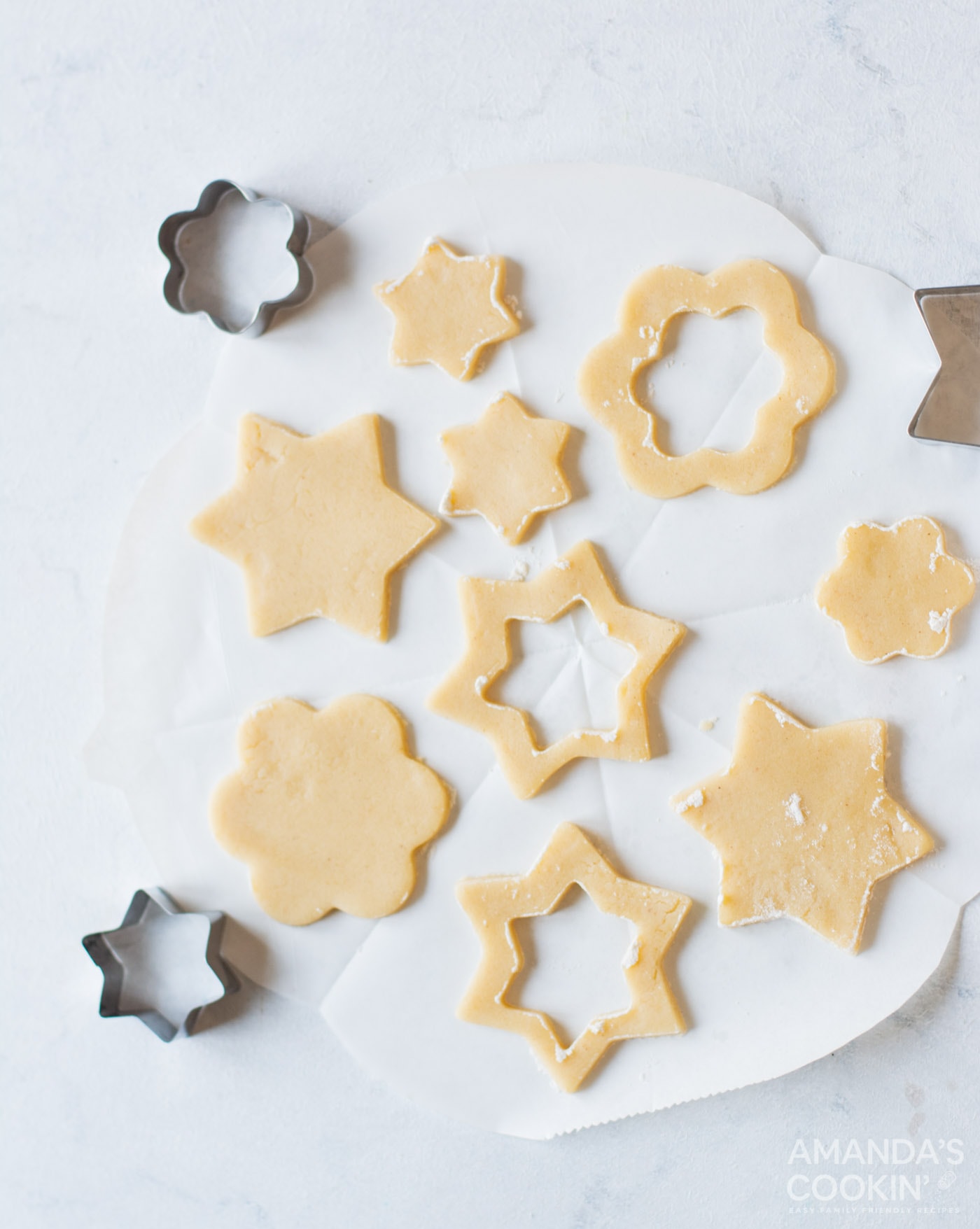 cookie dough cut by cookie cutters into shapes
