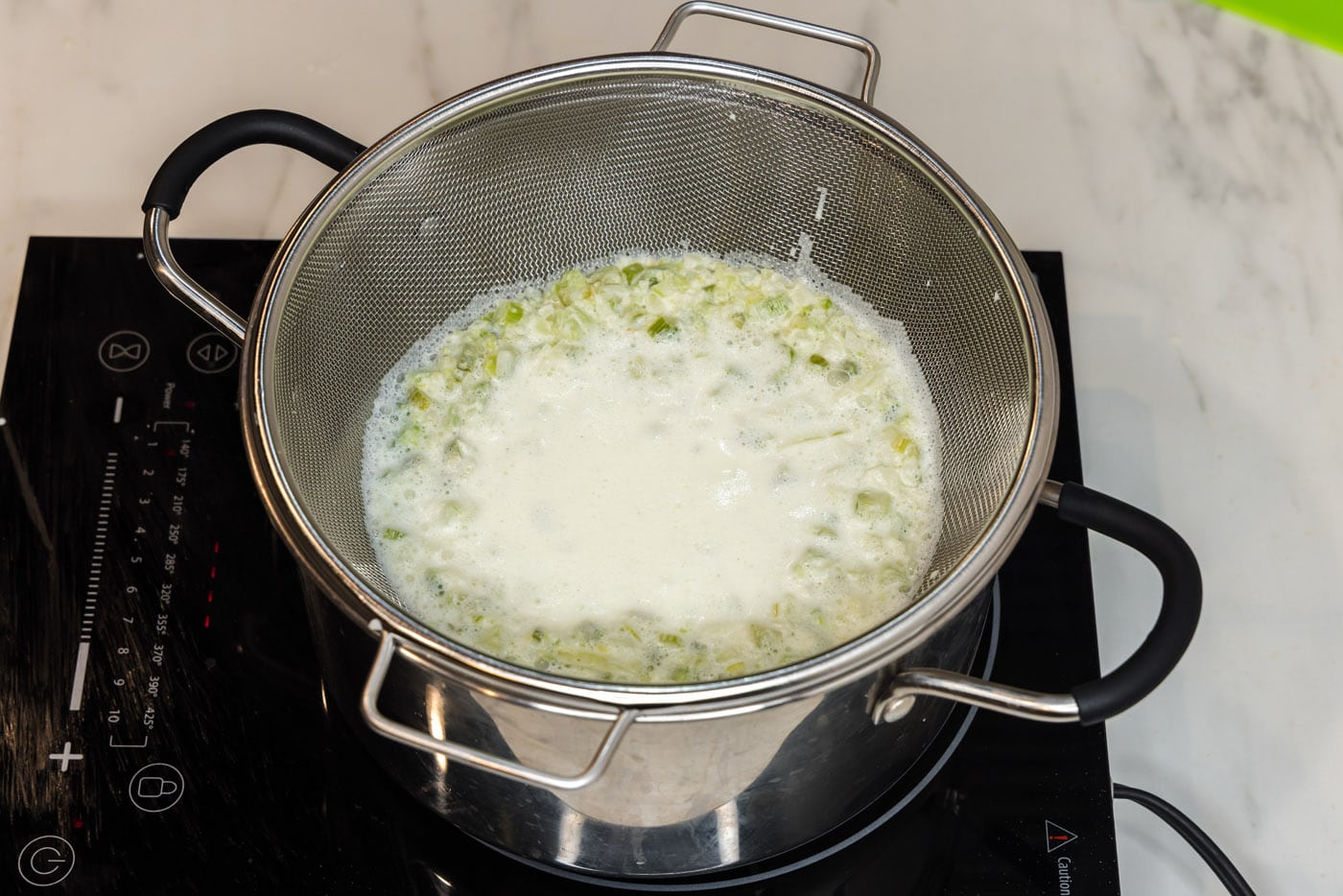 straining pasta sauce in a colander