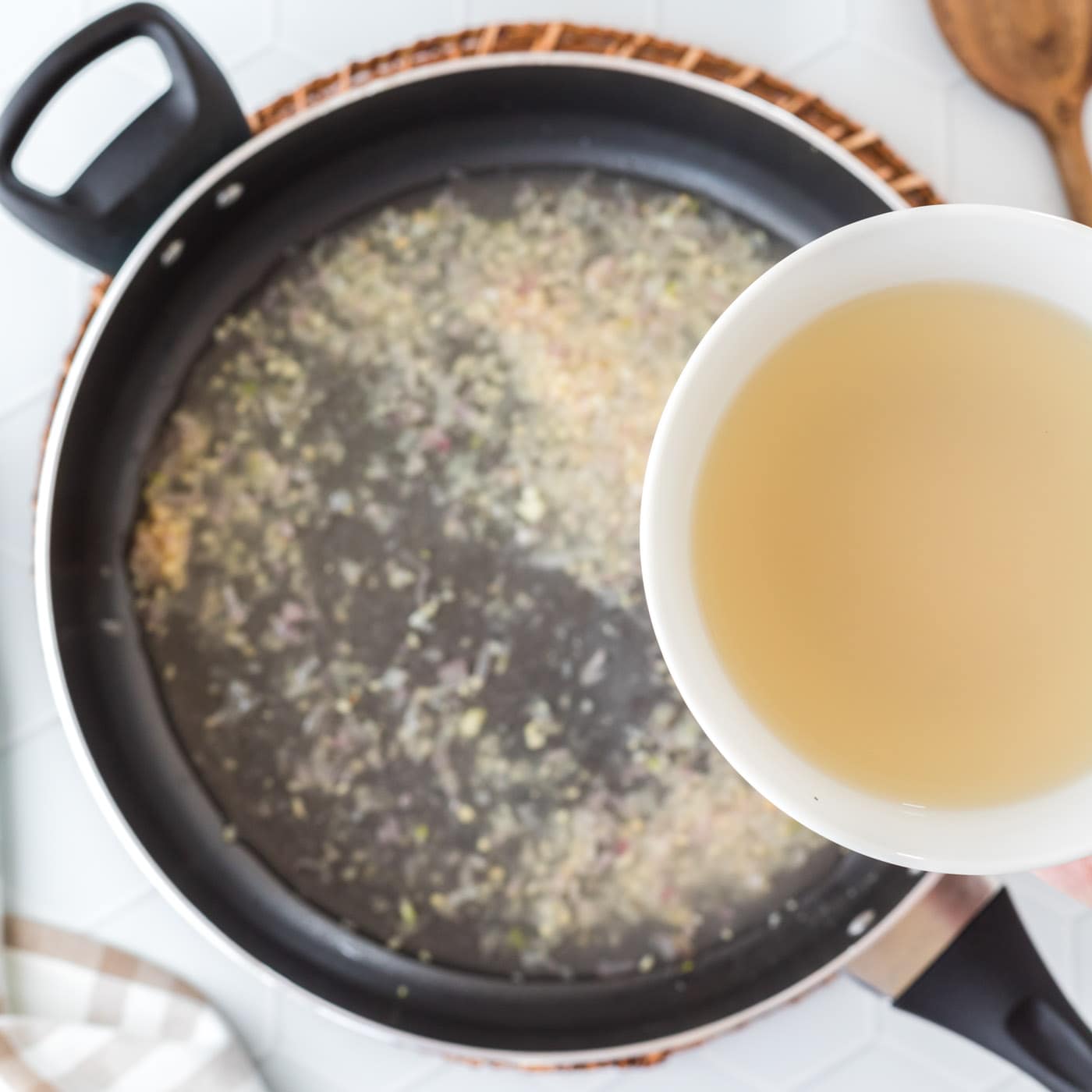 pour clam juice into pan with shallots and garlic