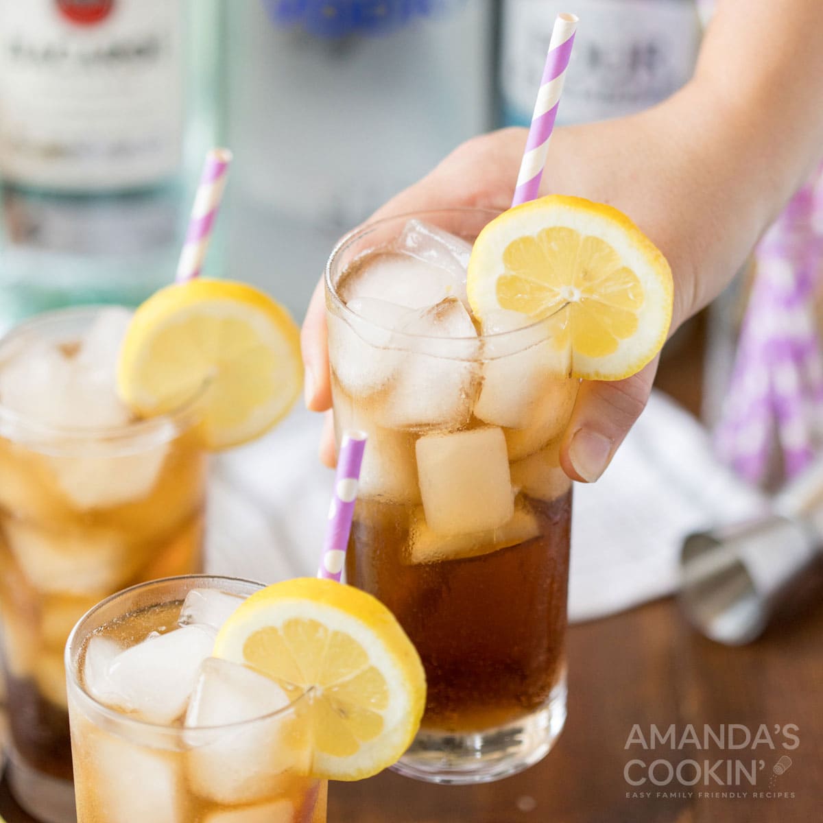 hand lifting glass of long island iced tea