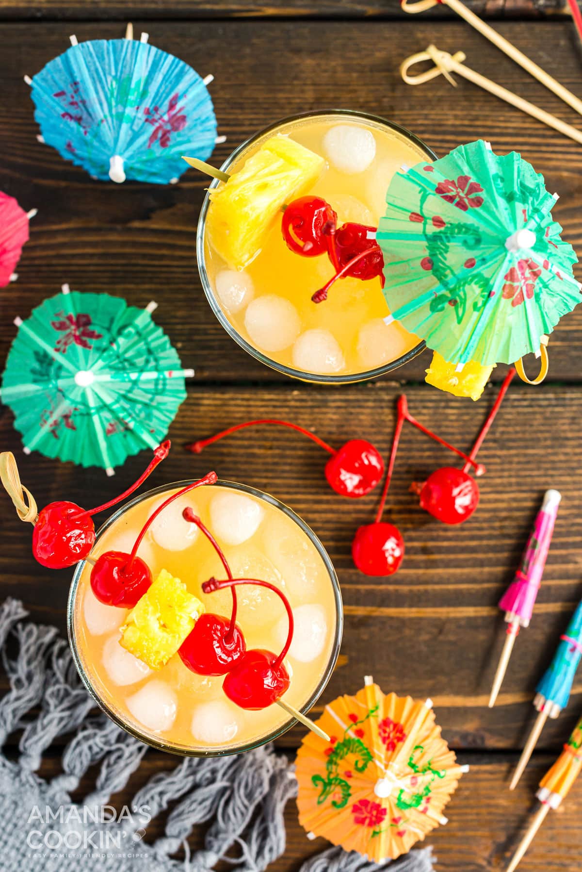overhead photo of mai tai cocktails with cherry garnishes
