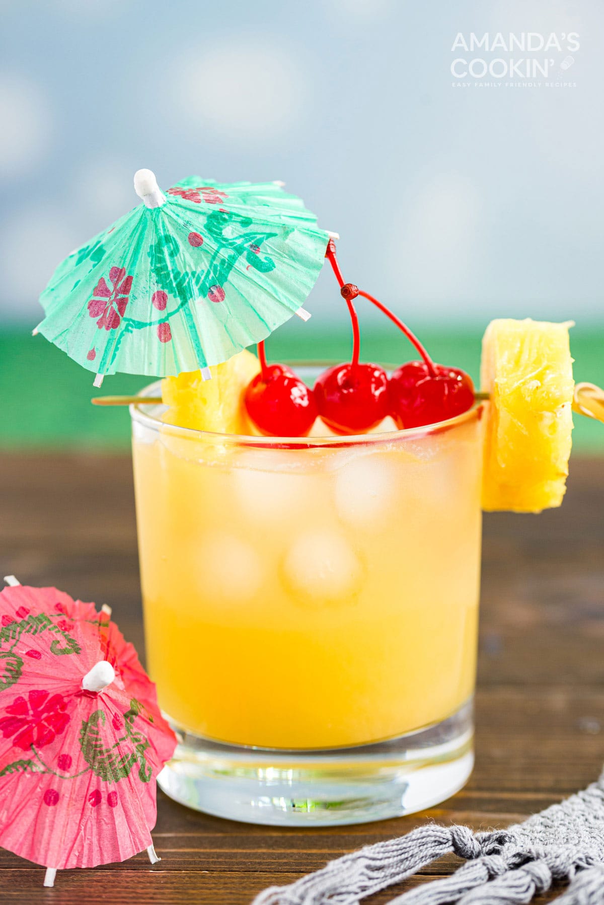 Mai Tai cocktail in a rock glass served with a cocktail umbrella