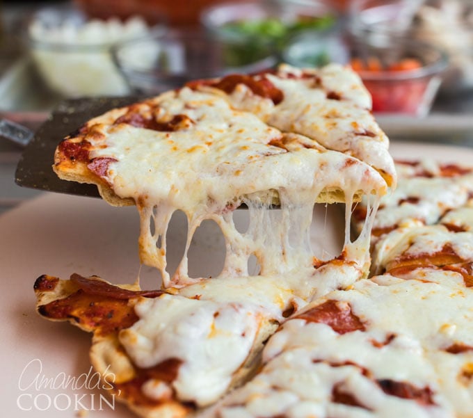 pizza slice being lifted from table with pie server