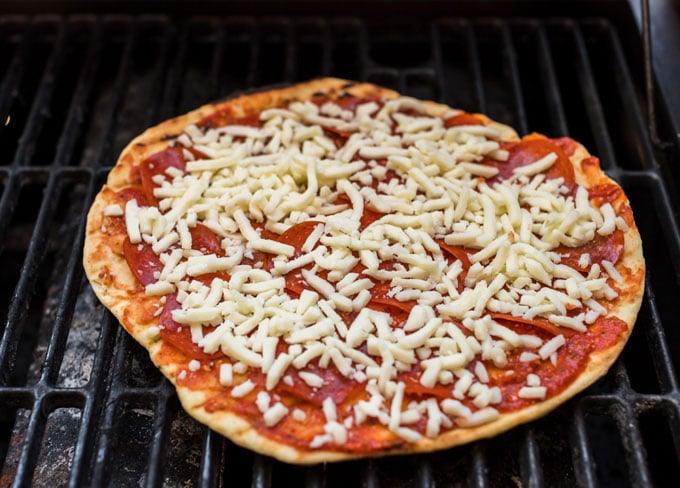 pizza cooking on a gas grill