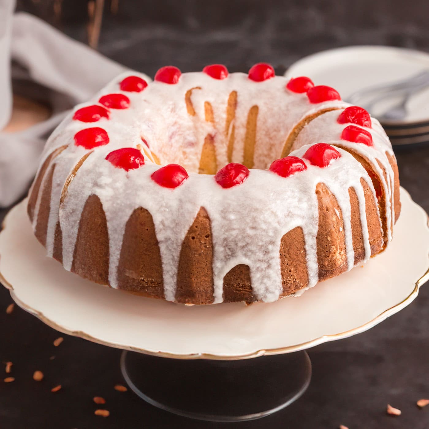 Maraschino Cherry Bundt Cake on a cake stand