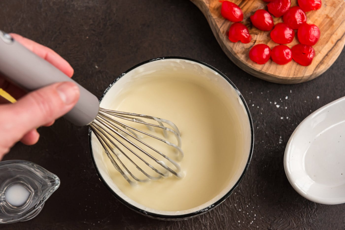 whisking almond butter glaze in a bowl