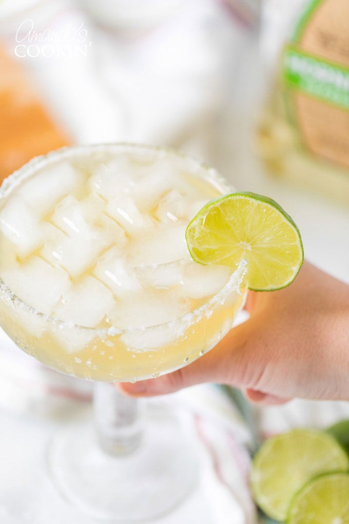 hand holding a margarita on the rocks
