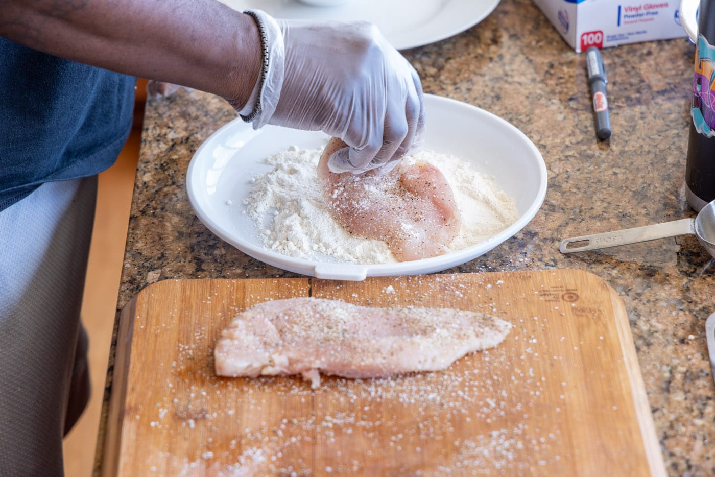 dredging chicken cutlets in flour