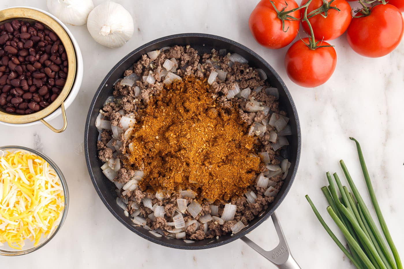 taco seasoning over ground beef and onion mixture