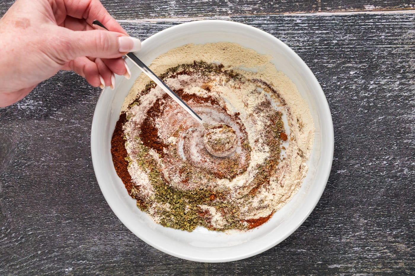 mixing mexican seasoning in a bowl