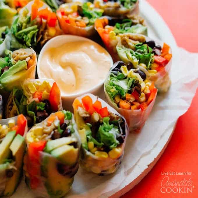 summer rolls on a plate with dip in the center