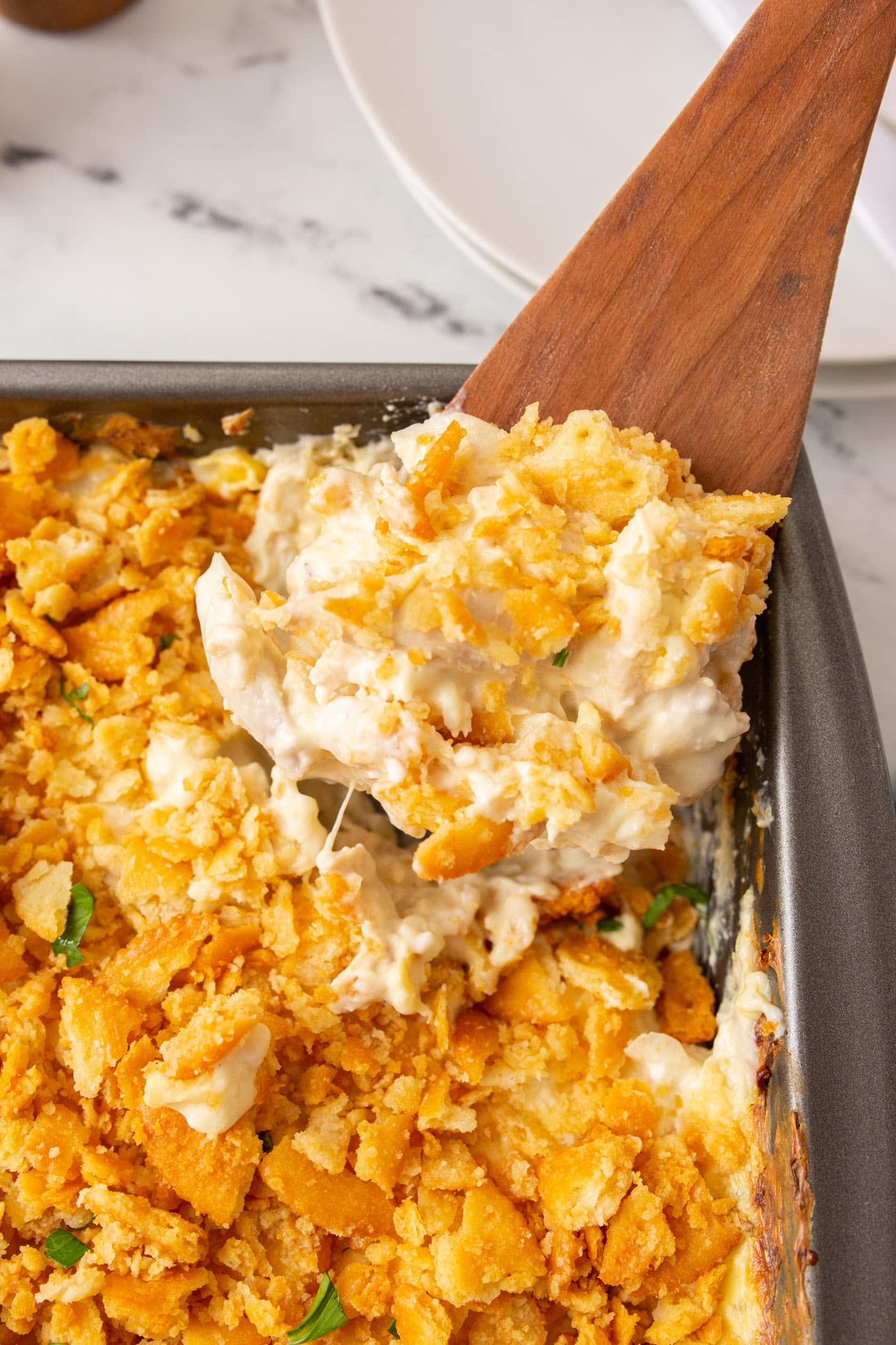 spooning out Million Dollar Chicken Casserole