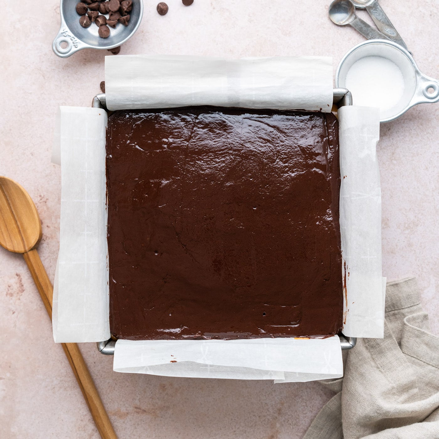 overhead of chocolate ganache on top of caramel and brownies