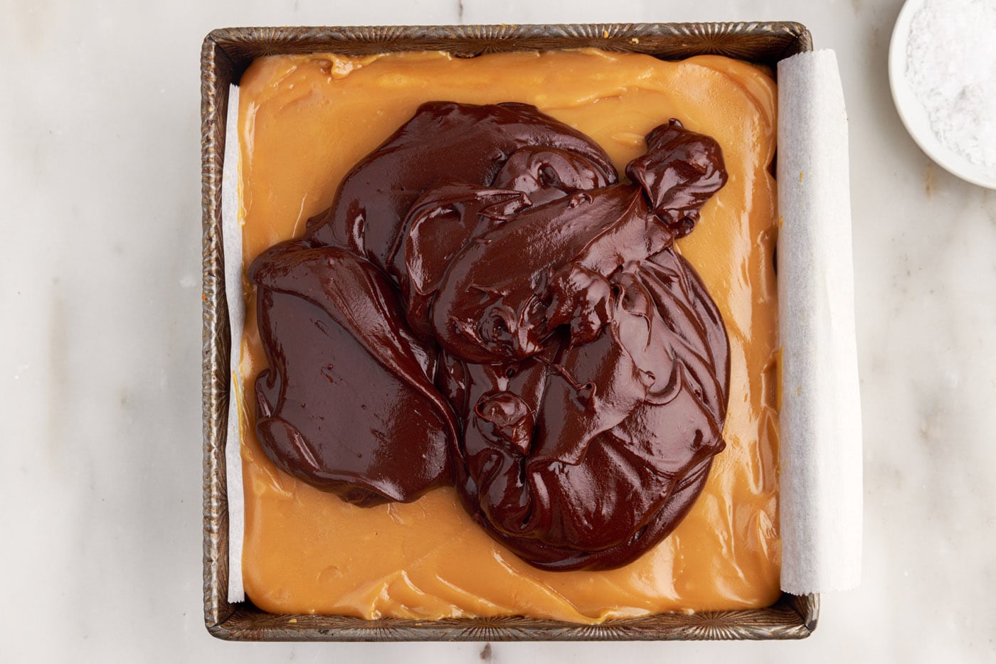 chocolate ganache poured over caramel