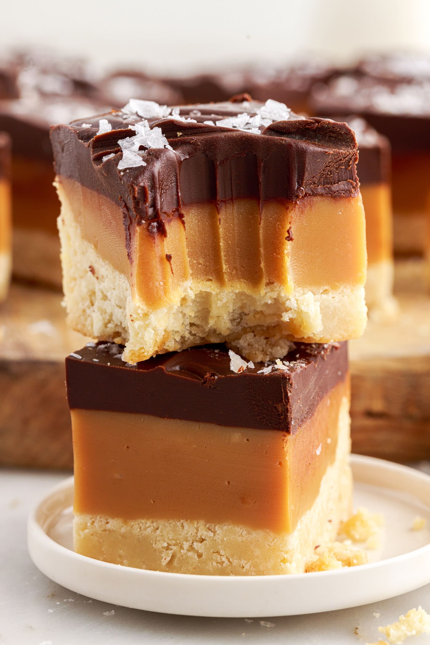 Two Millionaire’s Bars stacked on top of each other with a bite taken out of the top bar