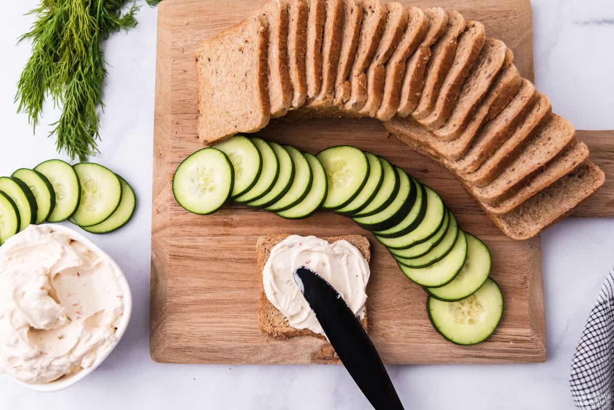 spreading cream cheese on bread