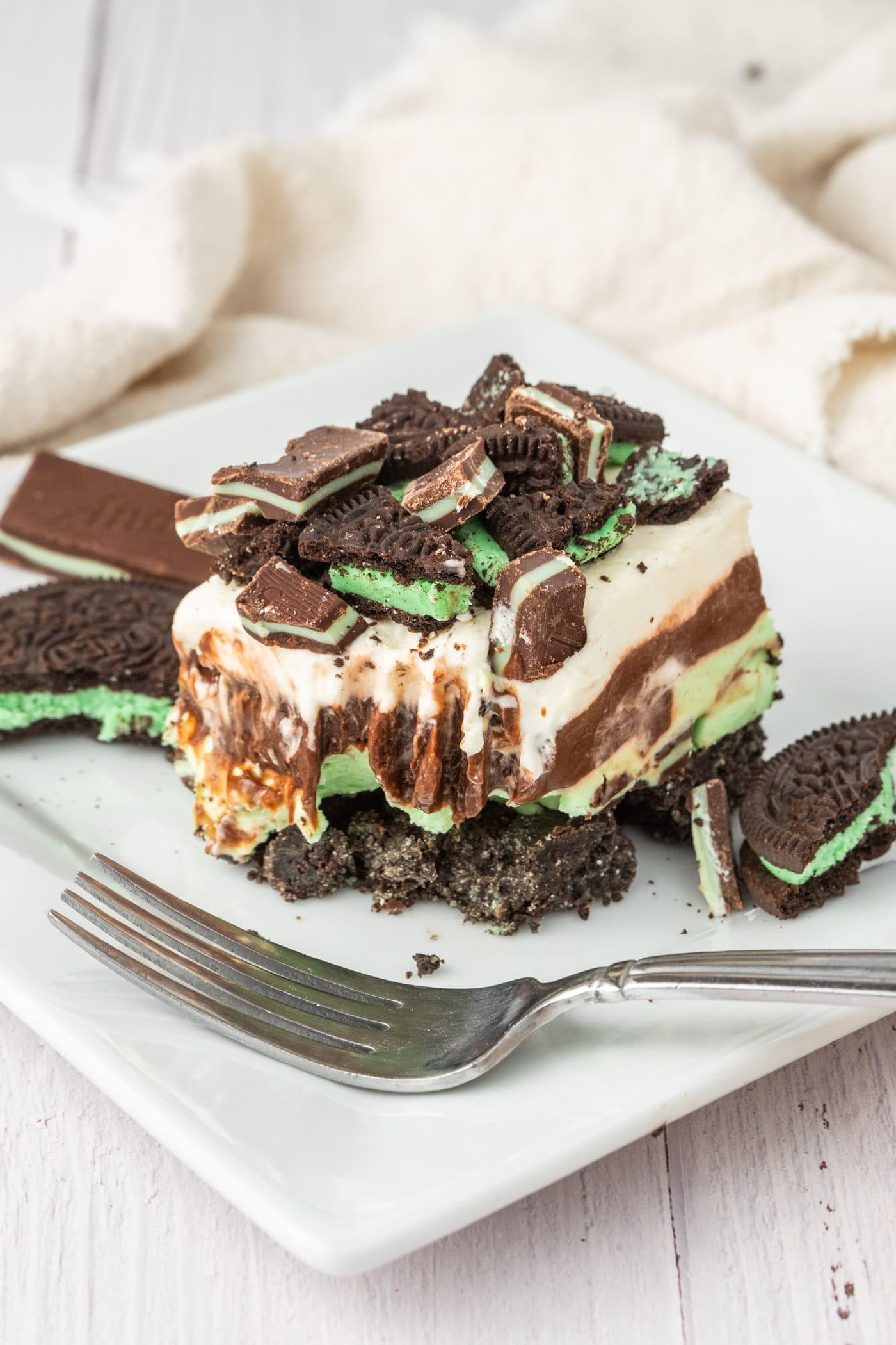 Mint Chocolate Dream Bar with a bite taken out on a plate with a fork