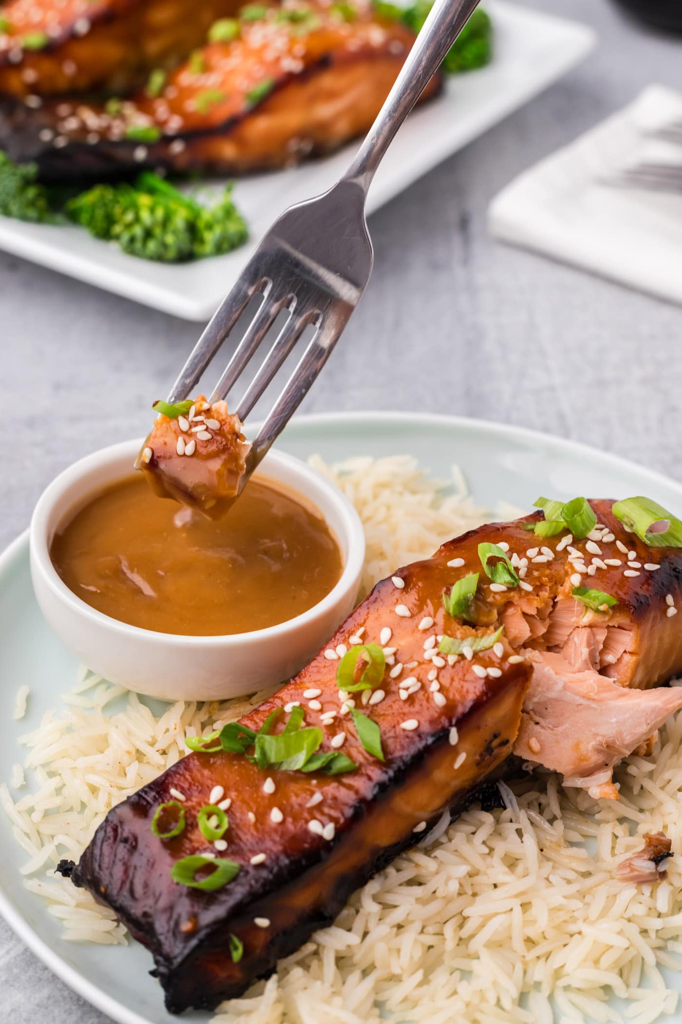 Piece of Miso Salmon being dipped into miso sauce