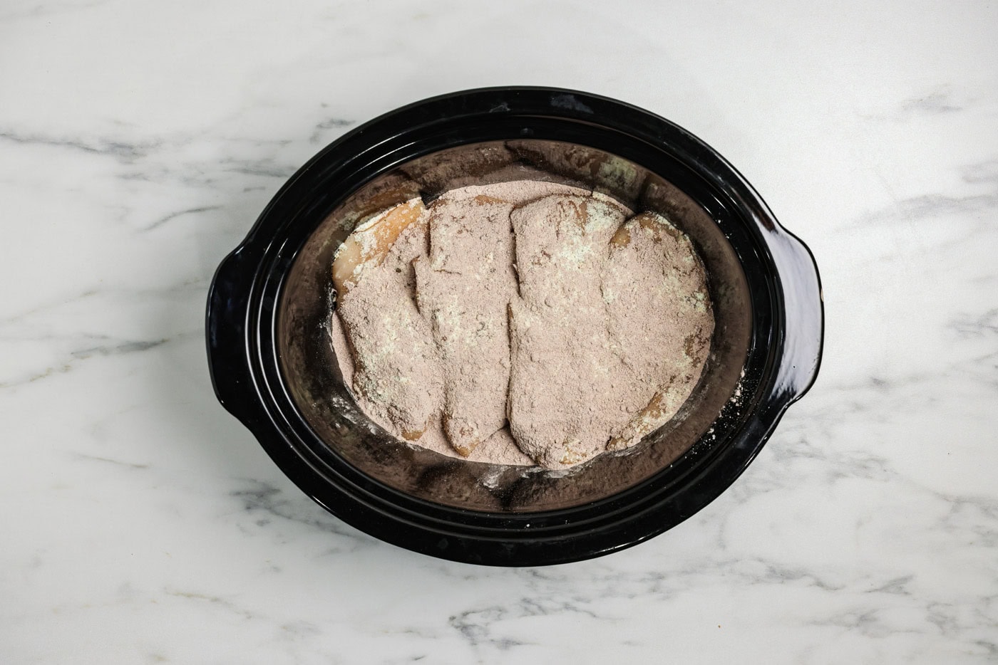 Au just packet sprinkled over ranch seasoning and chicken breasts in a crockpot