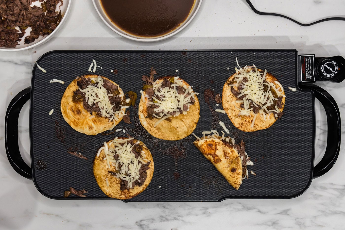 folding mississippi pot roast tacos inside a crisped tortilla