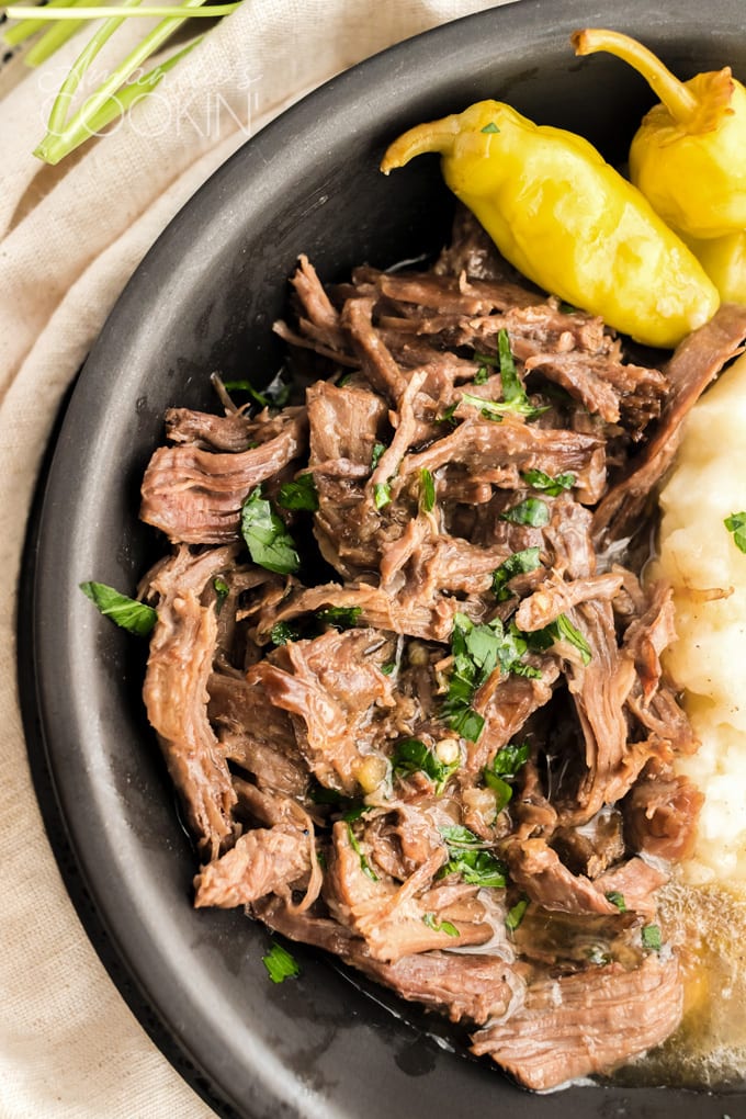 close up of stringy roast in bowl