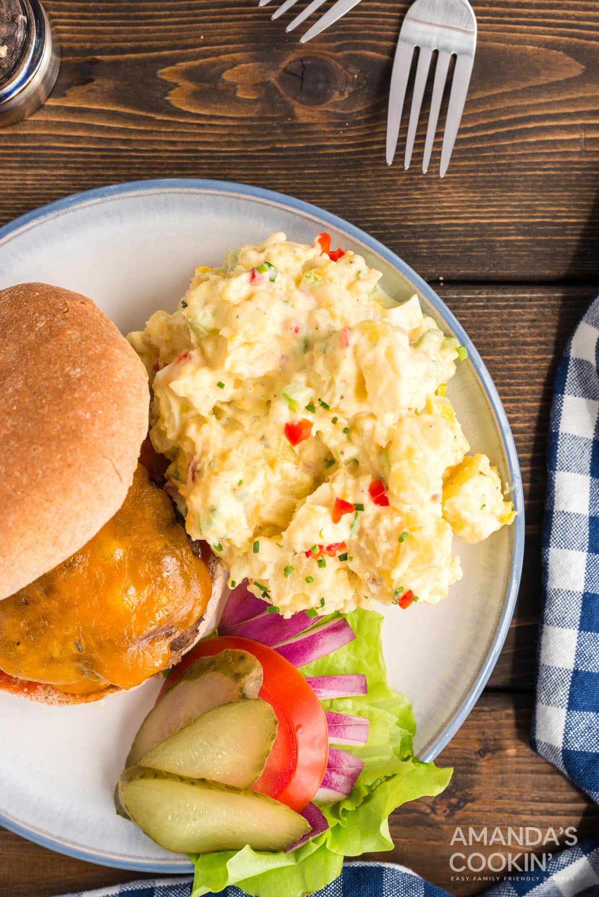potato salad on the side with a burger and toppings