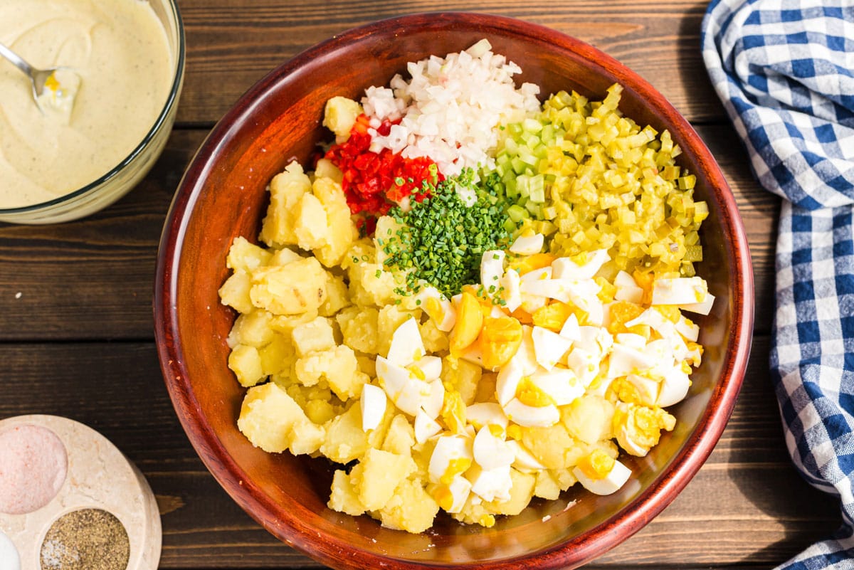 all potato salad ingredients in a bowl