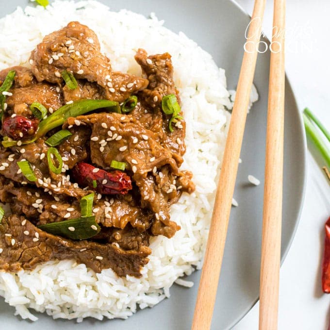 plate of mongolian beef with chop sticks