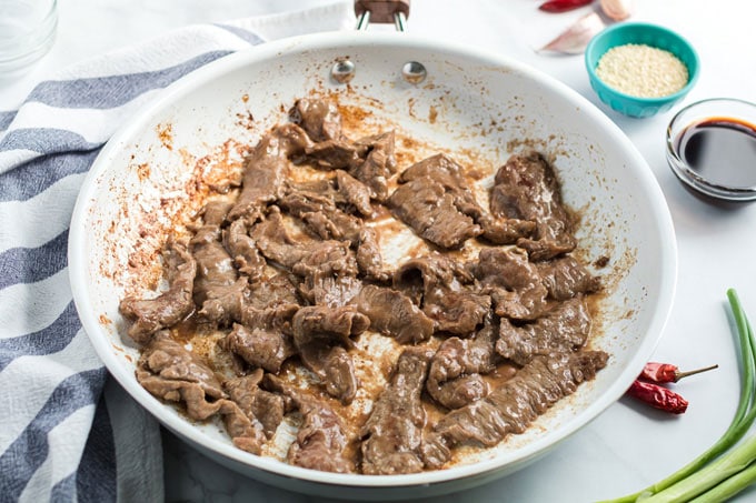 beef cooking in skillet