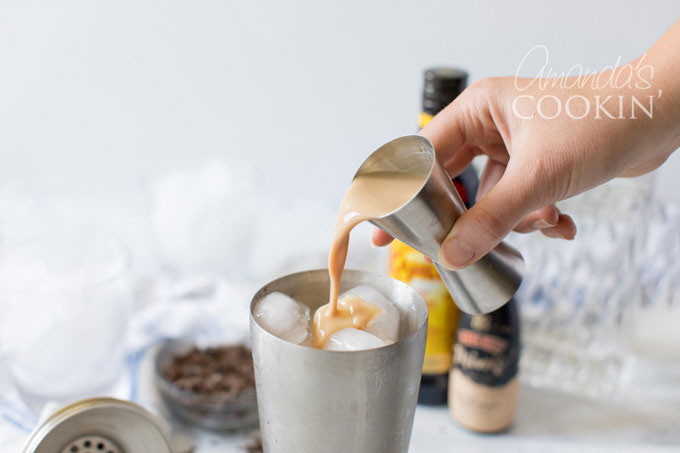 adding irish cream to cocktail shaker
