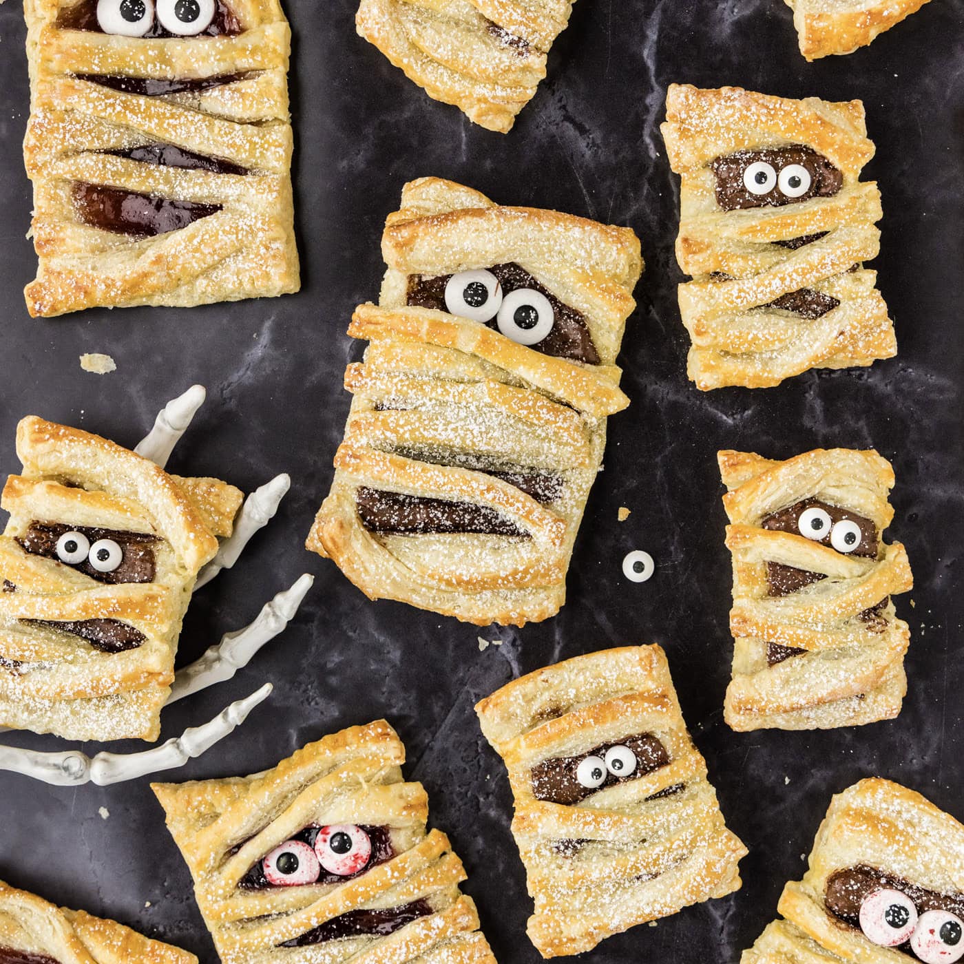 Mummy Hand Pies with one resting in a skeleton hand