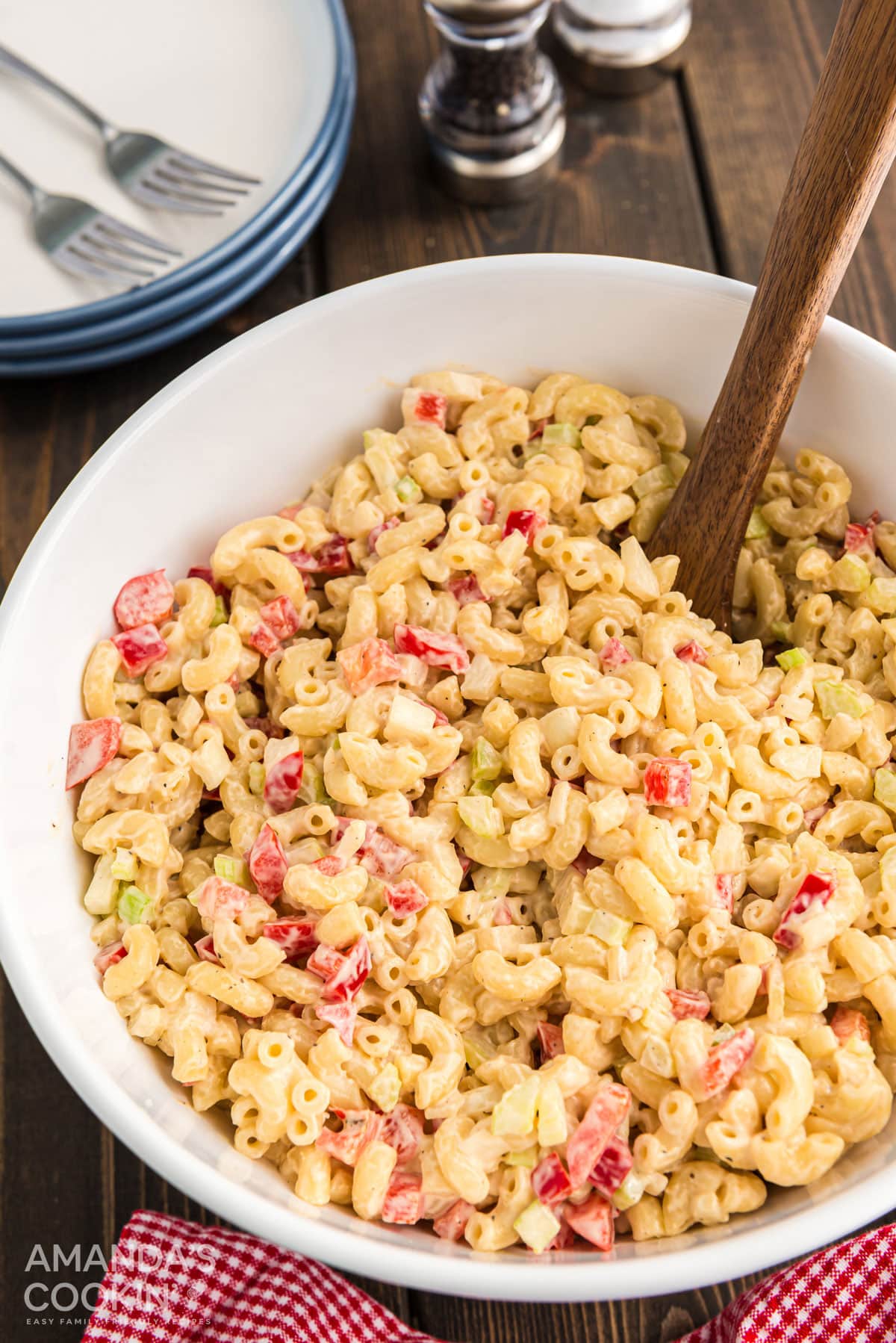 An overhead shot of a white bowl filled with macaroni salad.