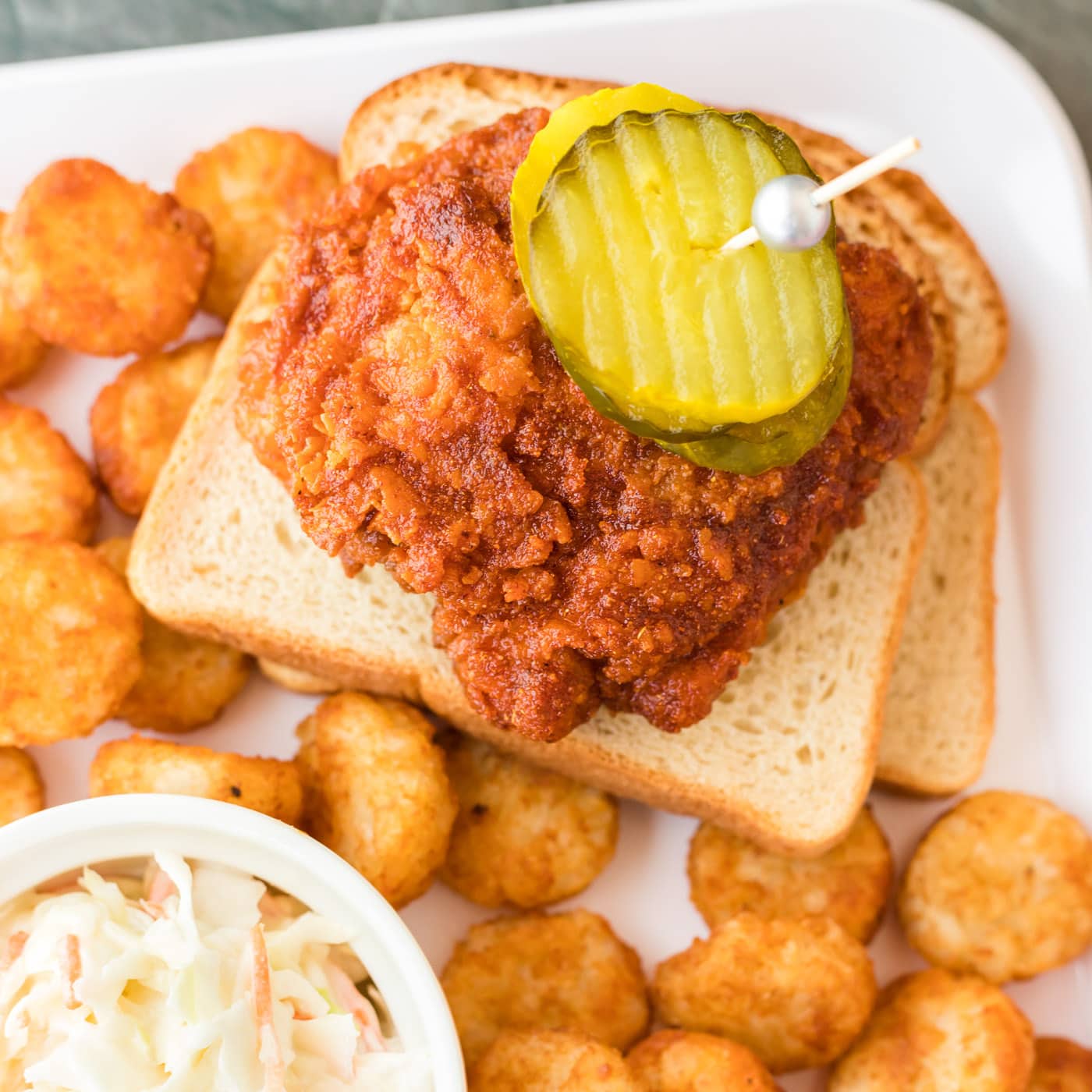 Piece of Nashville Hot Chicken resting on bread