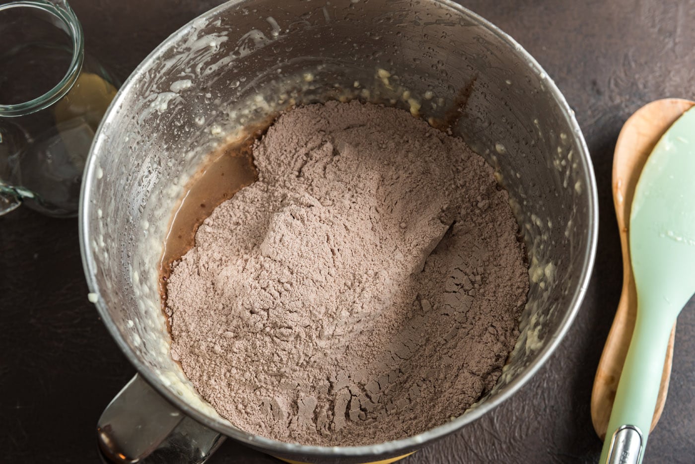 adding dry ingredients to butter mixture in a mixer bowl