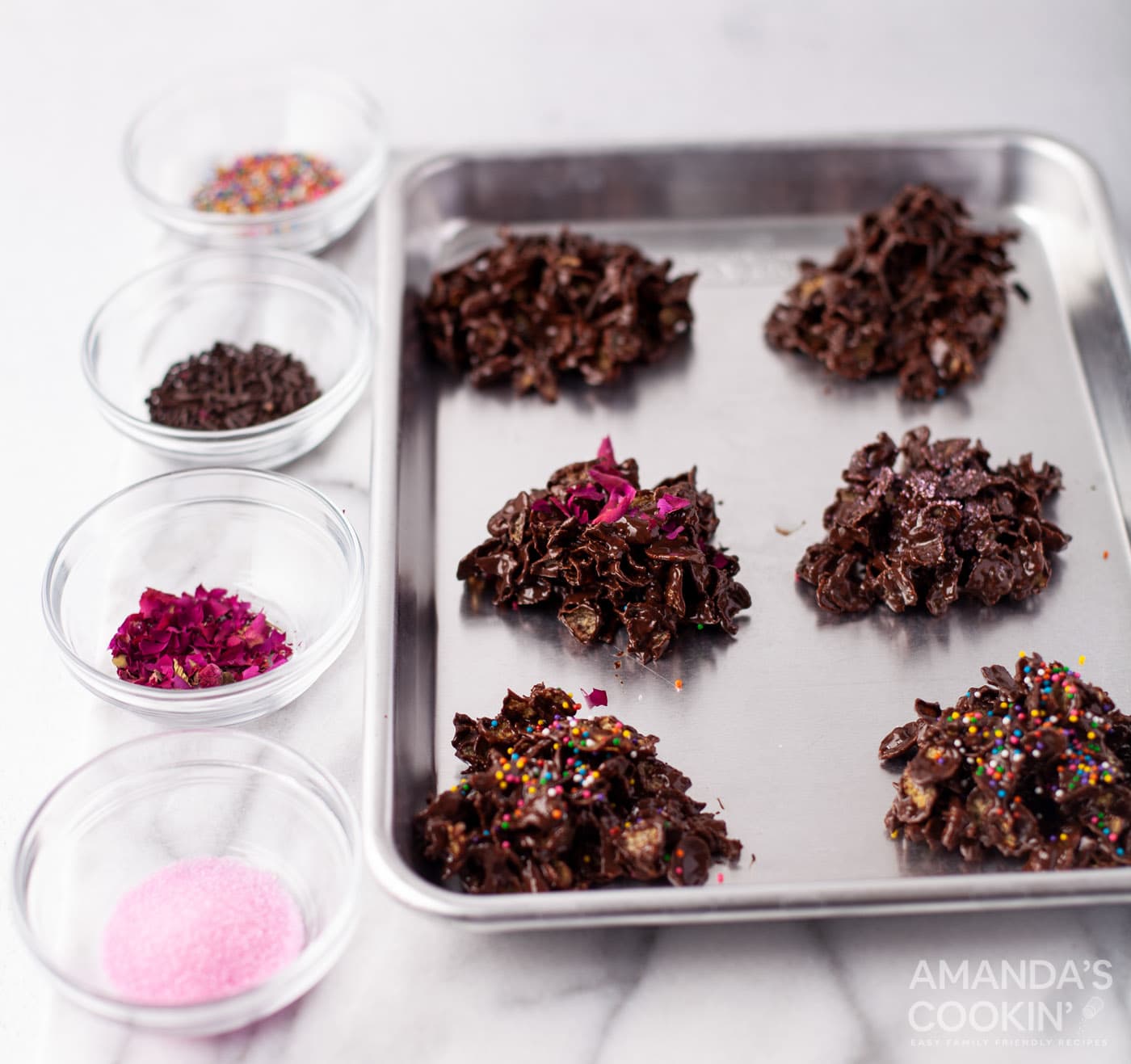 adding toppings to chocolate cornflake cookies