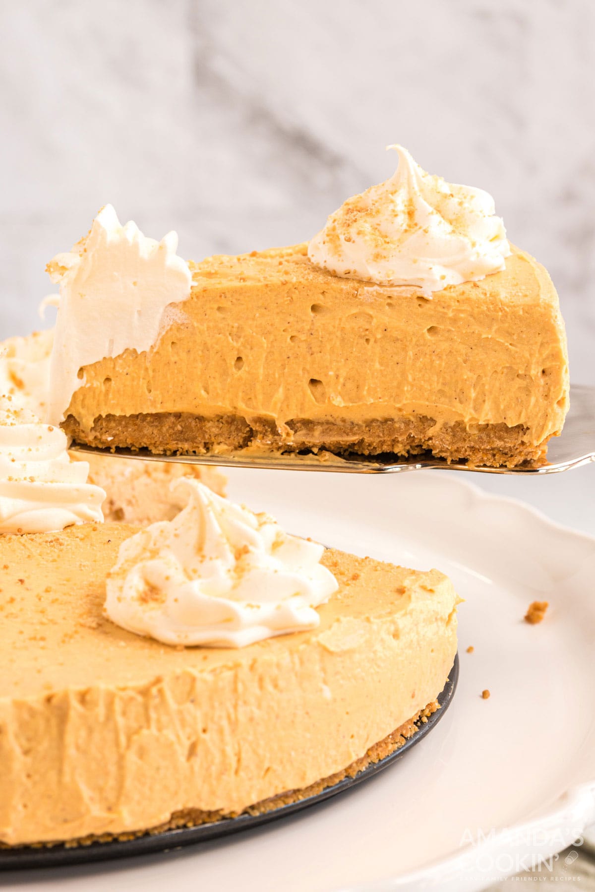 removing a slice of no bake pumpkin cheesecake
