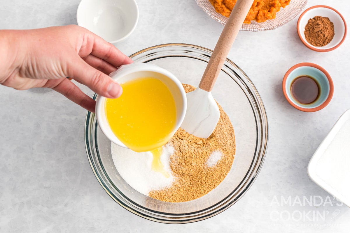 adding butter to graham cracker crumbs