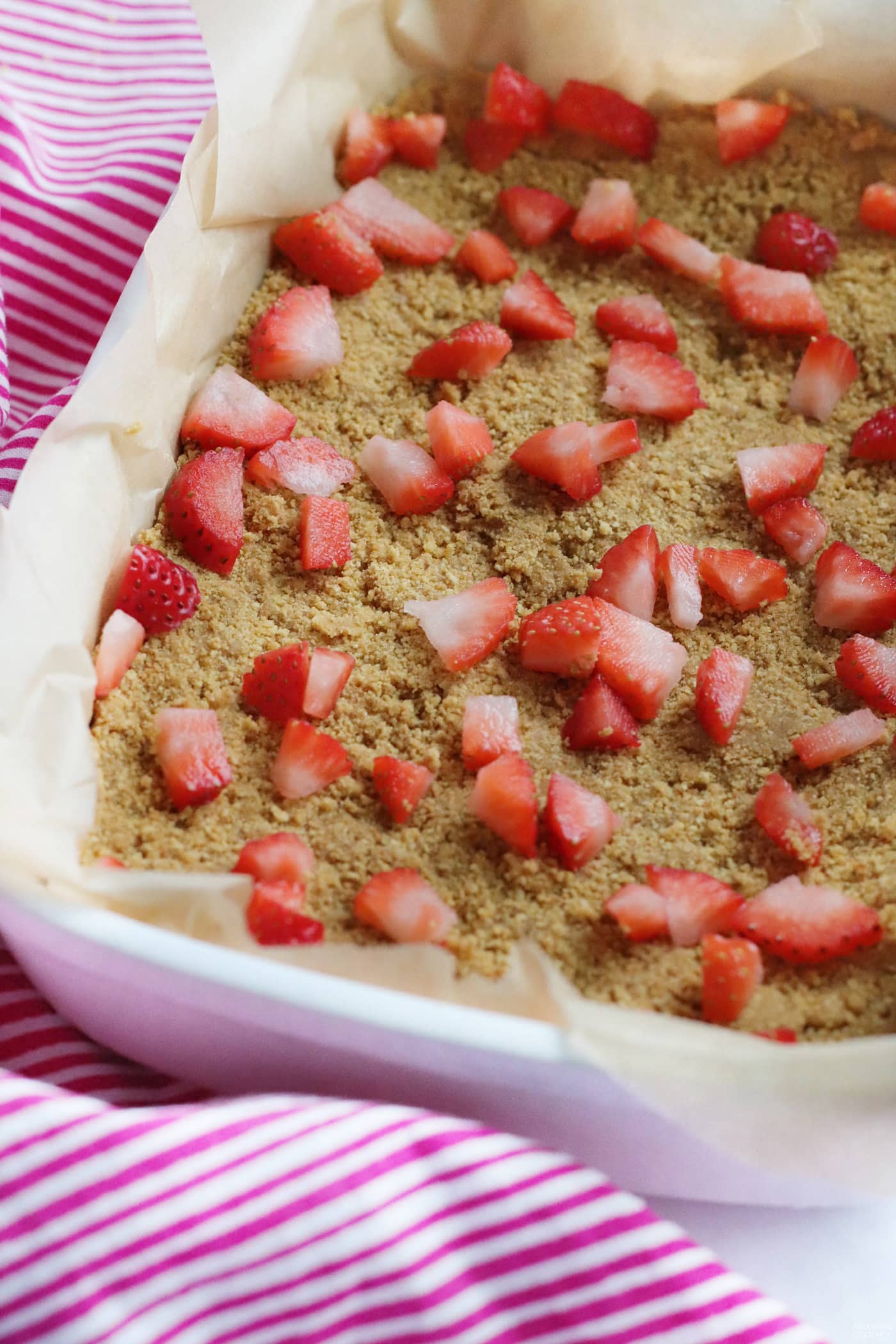 chopped strawberries on graham cracker crust