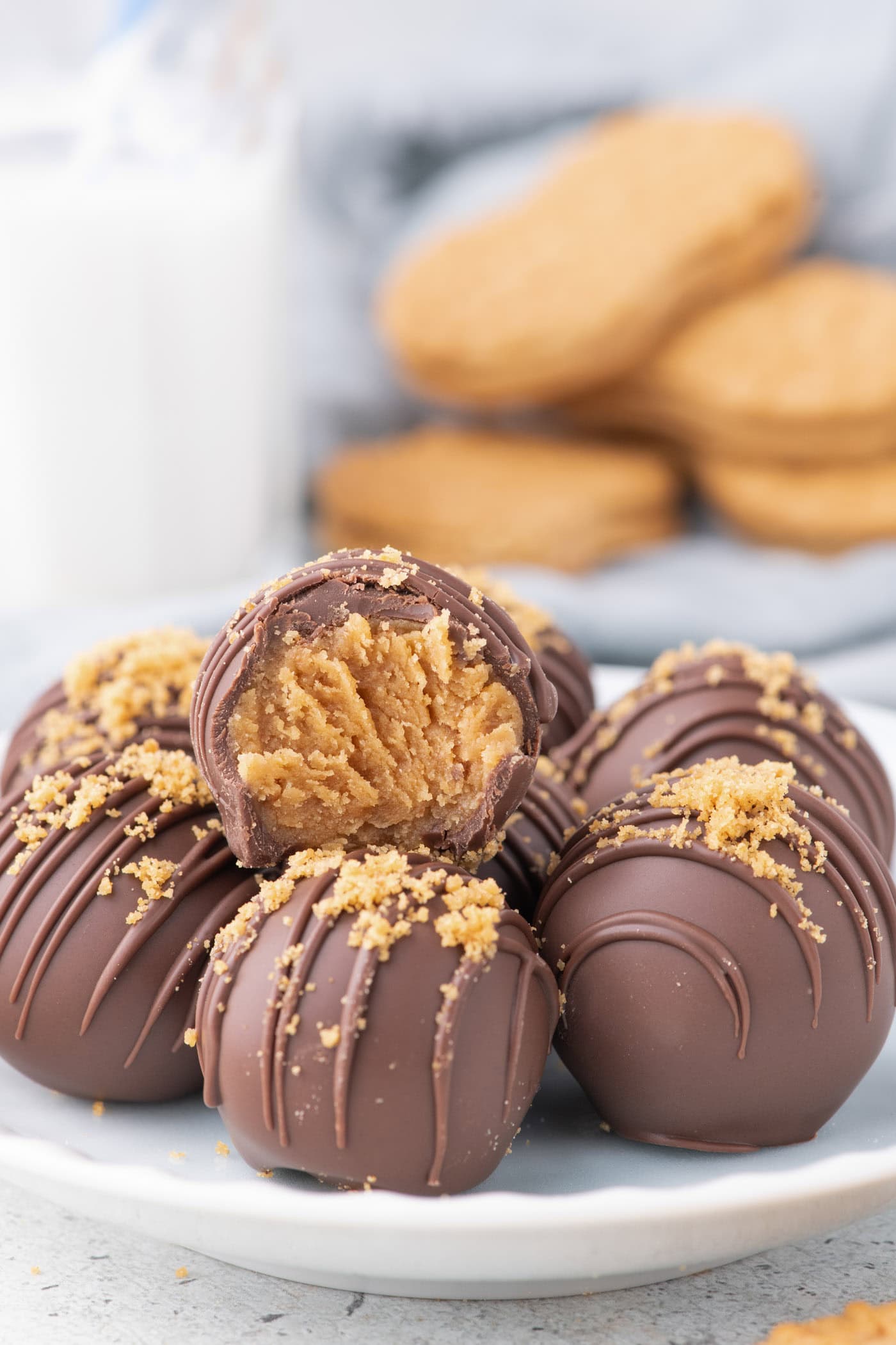 Nutter Butter Balls on a plate with a glass of milk in the background