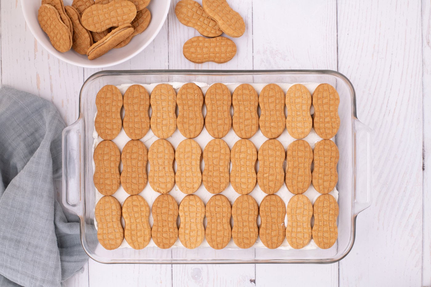 nutter butter cookies in a baking dish on top of whipped cream