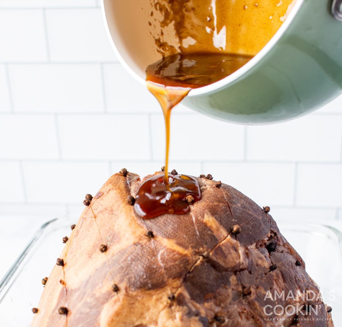 pouring glaze on ham