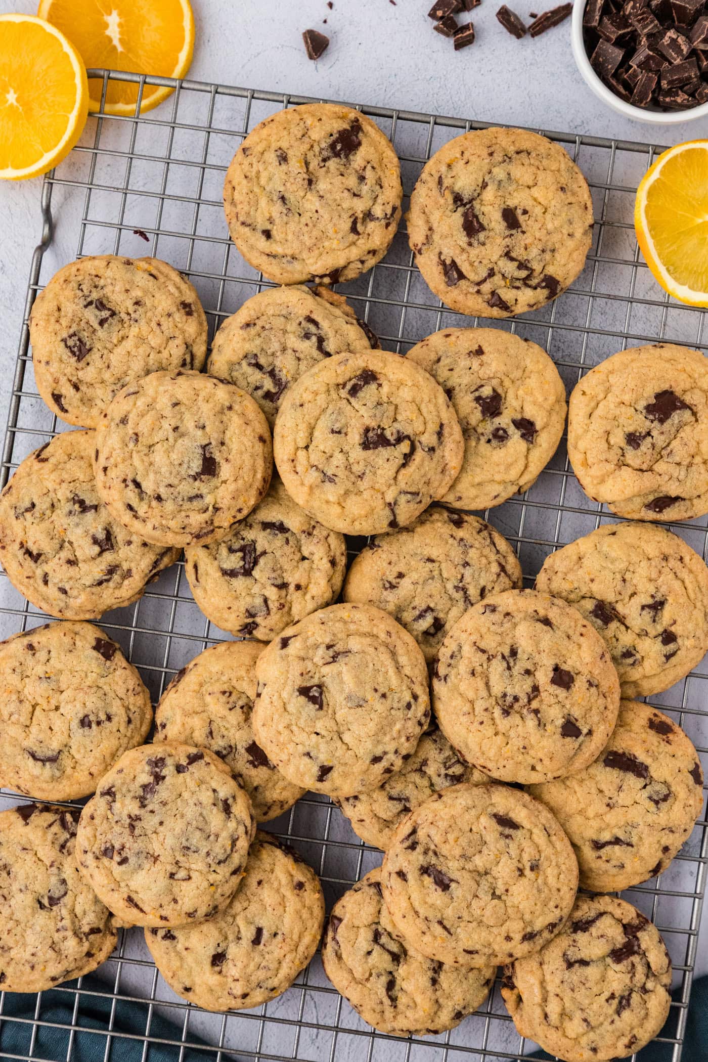 Pile of Orange Chocolate Chip Cookies on a wire rack