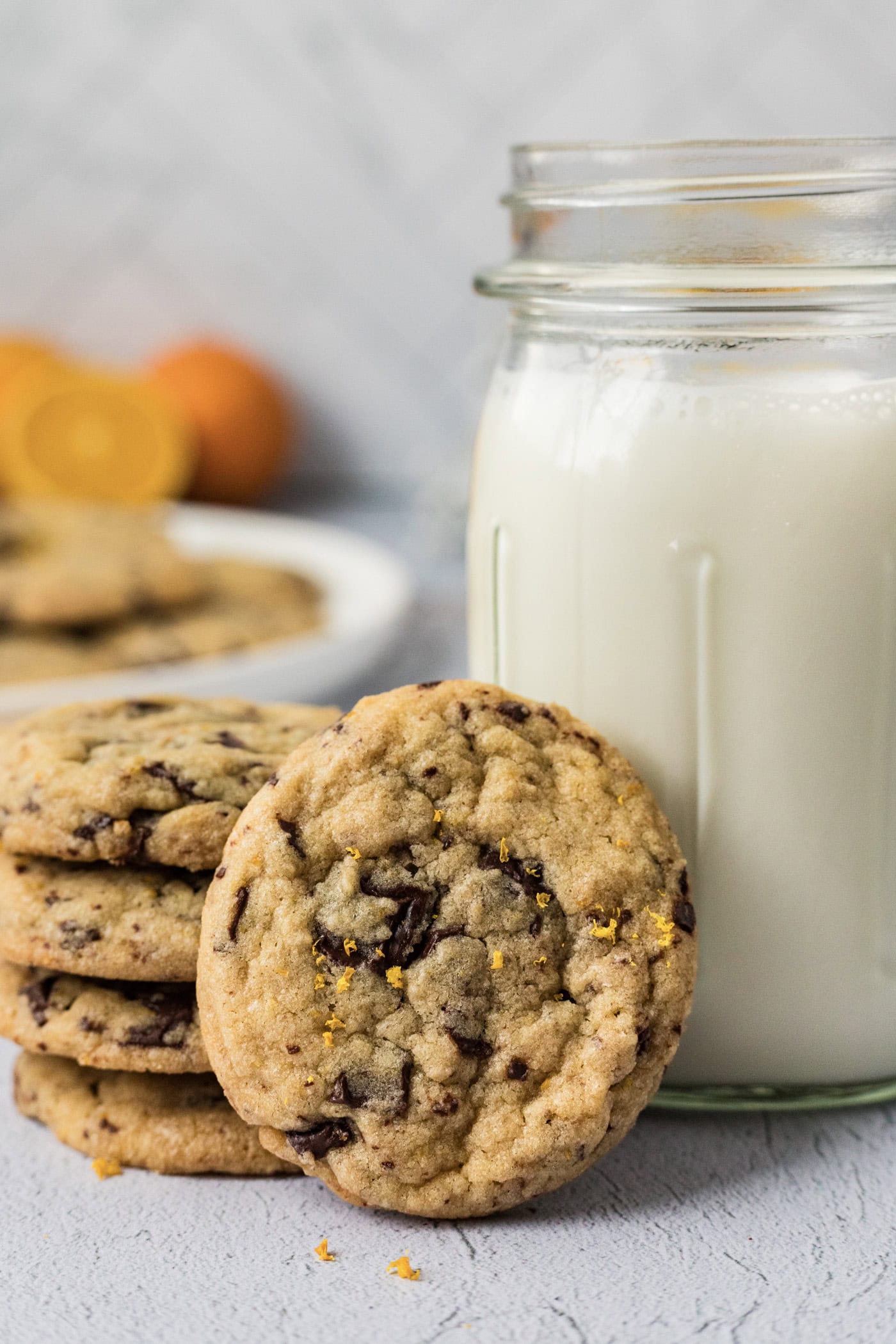 Orange Chocolate Chip Cookies resting against a glass of milk