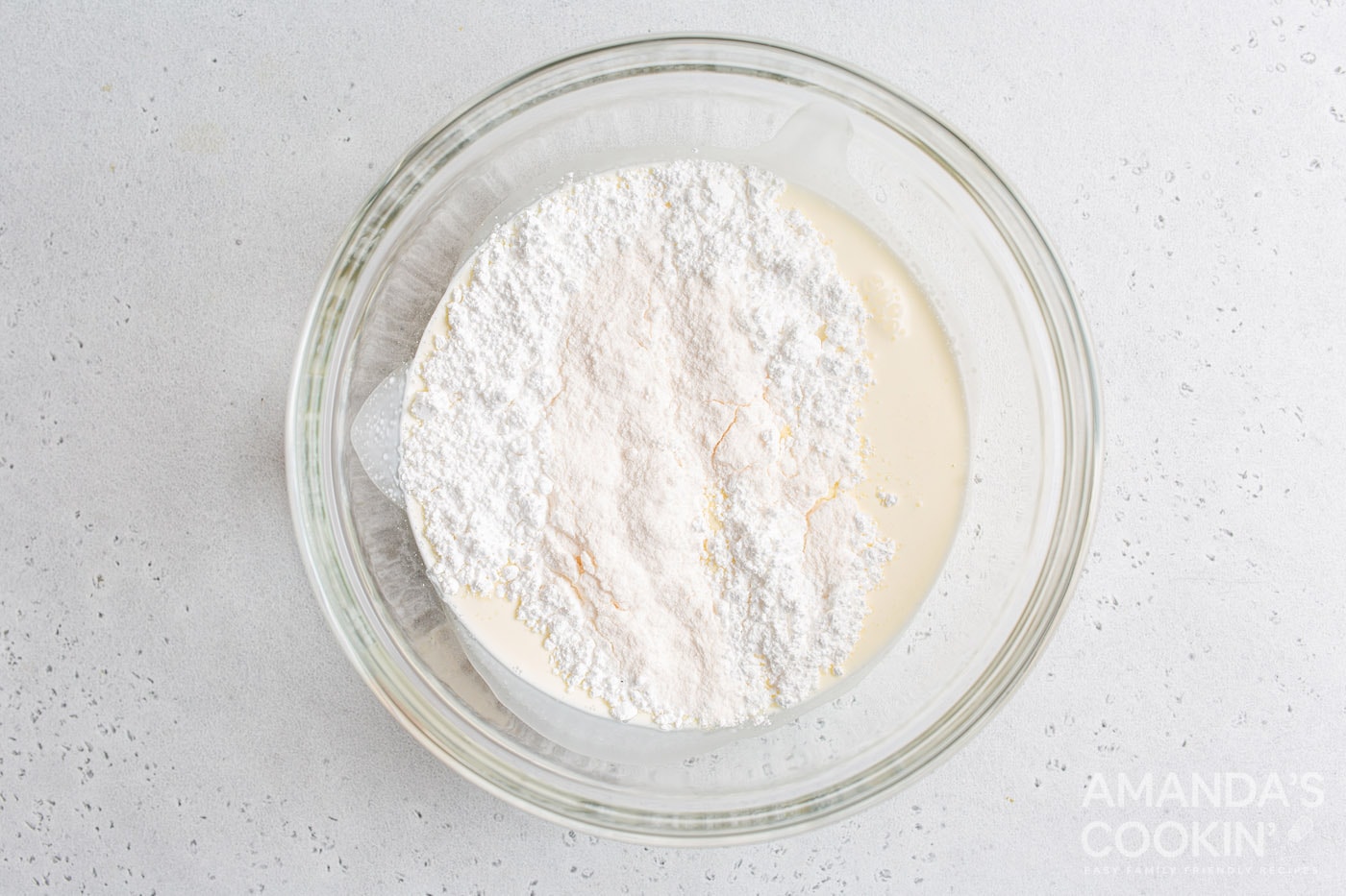 heavy whipping cream, powdered sugar, and vanilla pudding mix in a mixing bowl