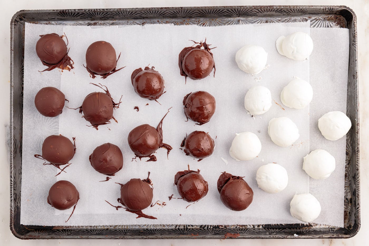 chocolate dipped oreo balls on a baking sheet