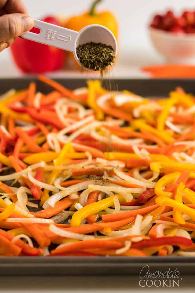 sprinkling dried herbs onto fresh vegetables