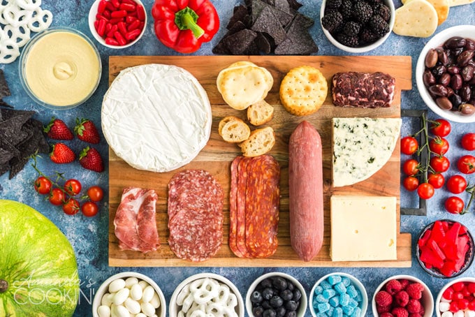 ingredients for charcuterie board laid out on cutting board
